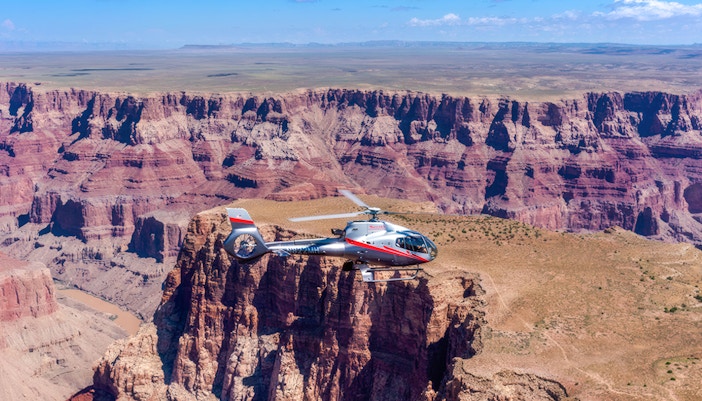Maverick helicopter flying over the Grand Canyon.