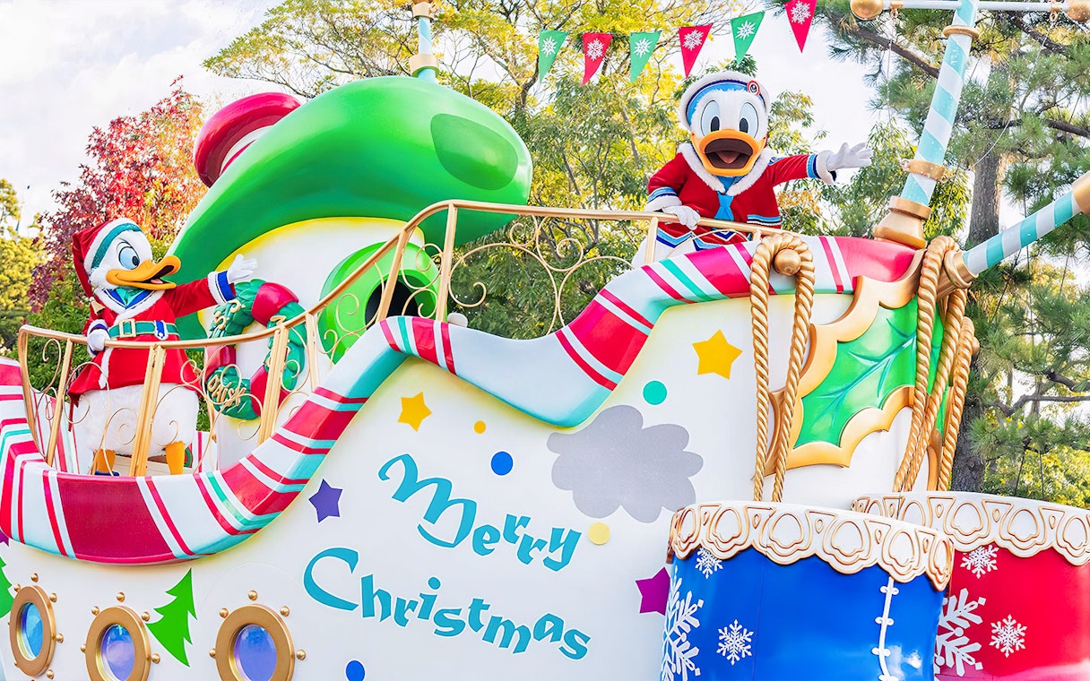 Tokyo Disneyland Christmas parade float with Donald Duck in festive attire.