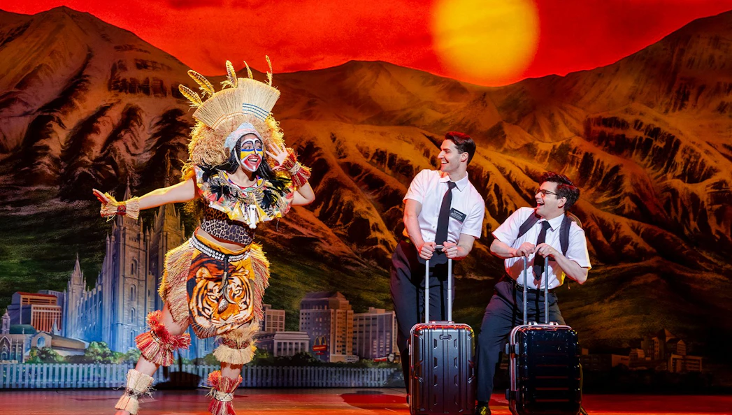 Stage performance of The Book of Mormon in Brisbane with actors in colorful costumes.