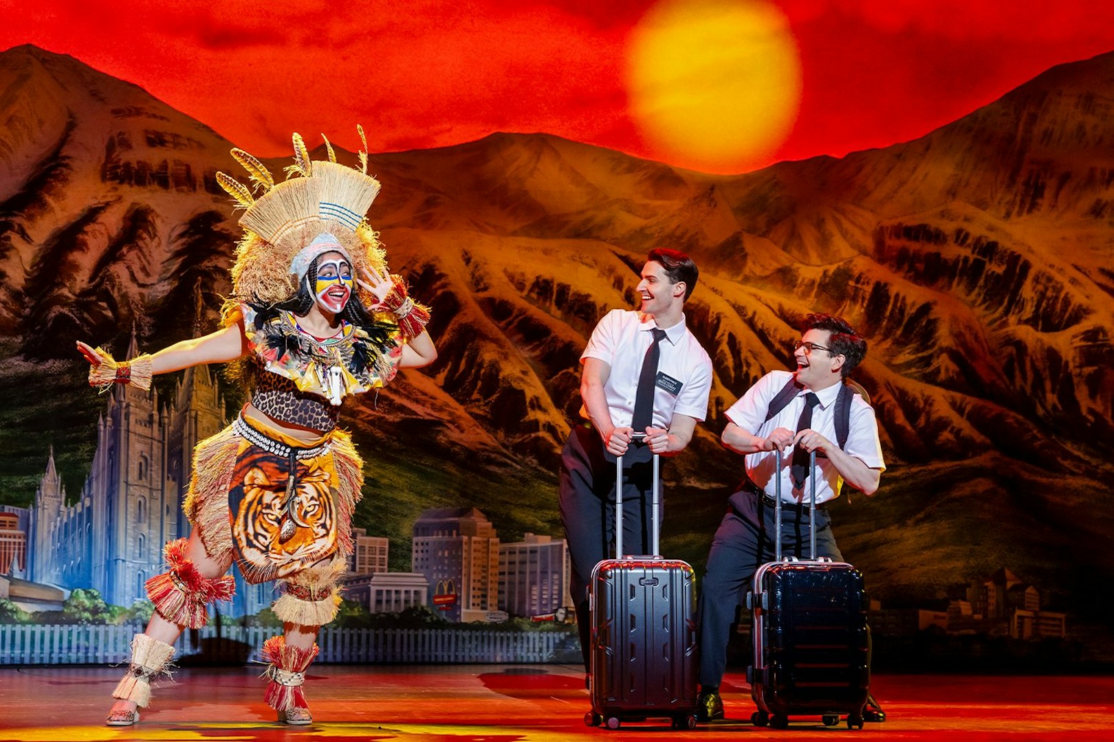 Stage performance of The Book of Mormon in Brisbane with actors in colorful costumes.