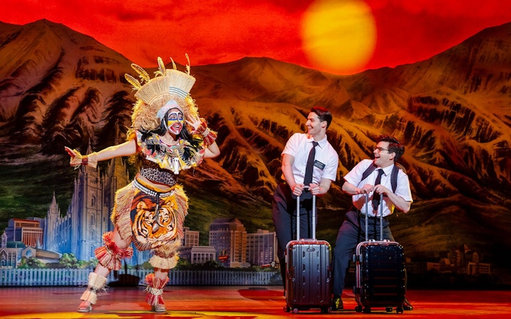 Stage performance of The Book of Mormon in Brisbane with actors in colorful costumes.