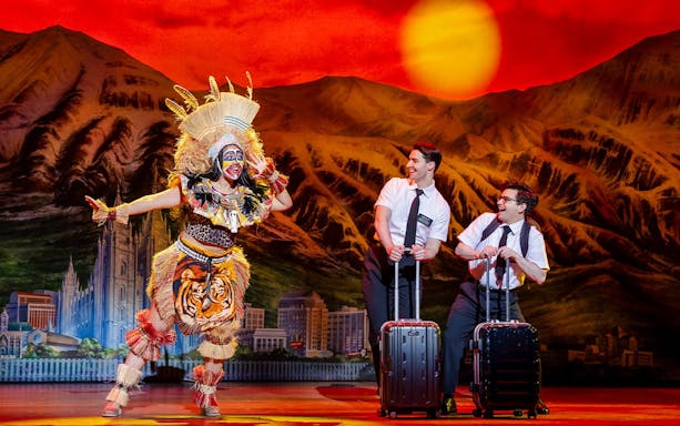 Stage performance of The Book of Mormon in Brisbane with actors in colorful costumes.