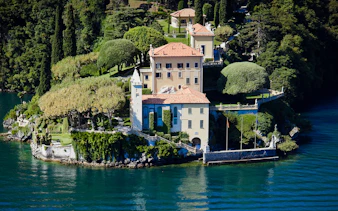 Villa del Balbianello surrounded by lush gardens on Lake Como, Italy.