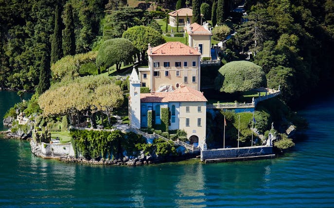 Villa del Balbianello surrounded by lush gardens on Lake Como, Italy.