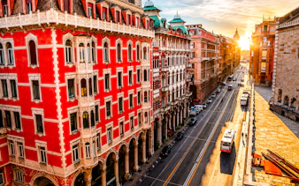 Street view of historic buildings in Genoa during sunset, part of a walking dinner tour.