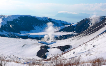 Snow-covered Mt. Usu with steam vents in Hokkaido during the Sapporo winter day tour.