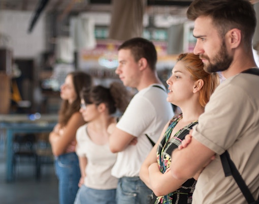 Visitors observing artwork in a modern art gallery.