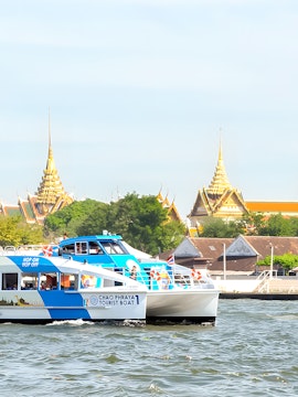 Hop-On-Hop-Off Chao Phraya Tourist Boat cruising past Bangkok temples.
