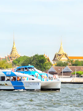 Hop-On-Hop-Off Chao Phraya Tourist Boat cruising past Bangkok temples.