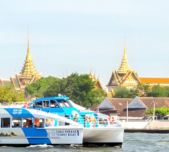 Hop-On-Hop-Off Chao Phraya Tourist Boat cruising past Bangkok temples.