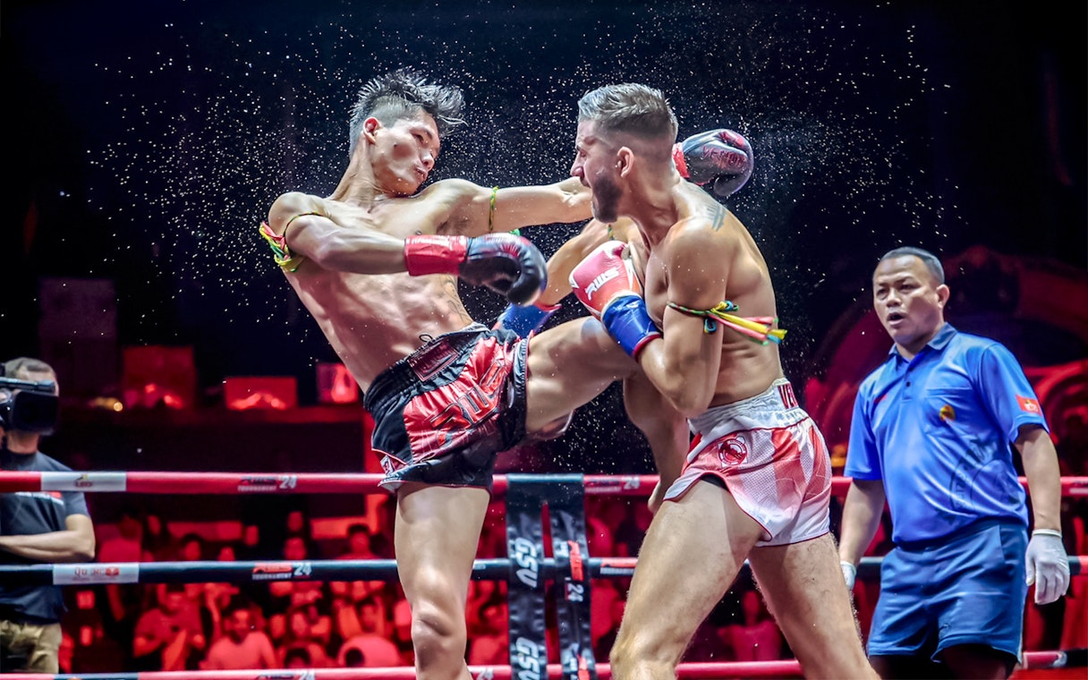 Muay Thai fighters in action at Rajadamnern Boxing Stadium, Bangkok.