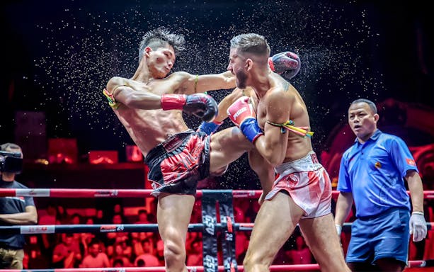 Muay Thai fighters in action at Rajadamnern Boxing Stadium, Bangkok.
