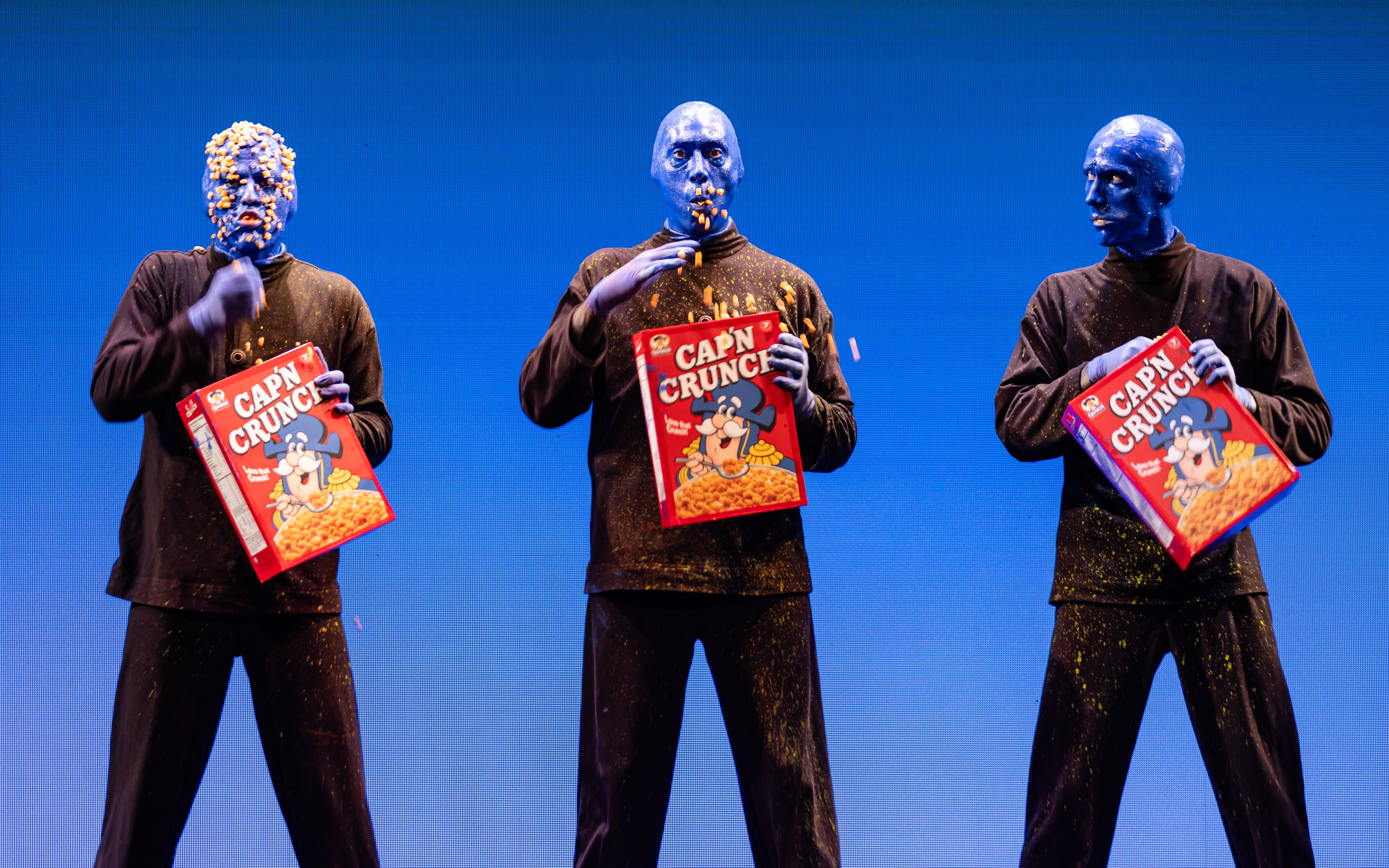 Blue Man Group performing with cereal boxes on stage, Orlando.