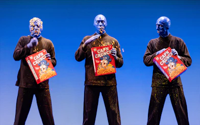 Blue Man Group performing with cereal boxes on stage, Orlando.