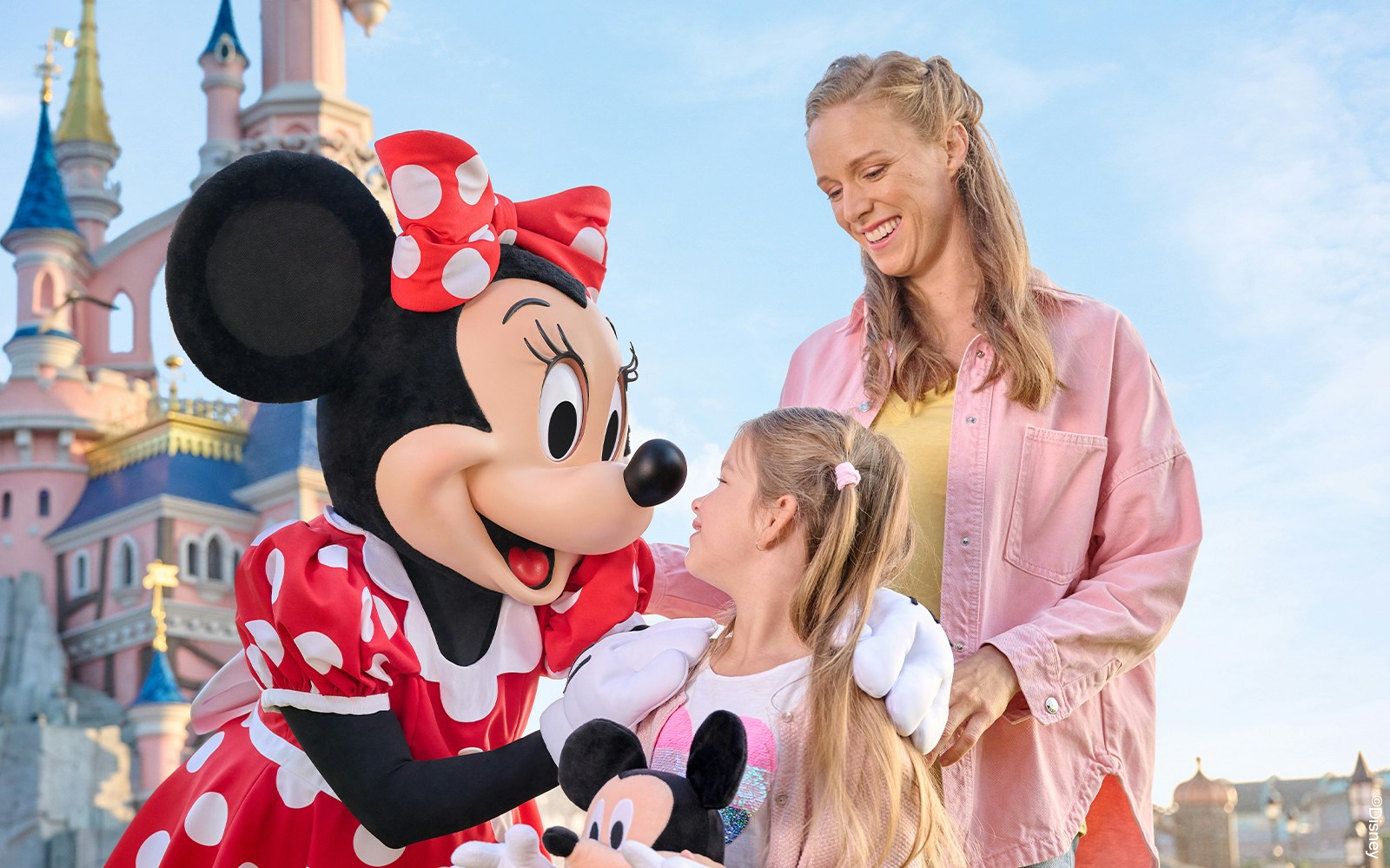 Disney characters meeting guests at Disneyland Paris entrance.