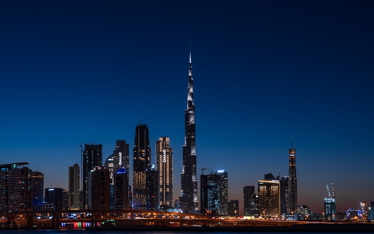 Dubai skyline at night featuring the illuminated Burj Khalifa on the Big Bus Dubai Night Tour.