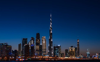 Dubai skyline at night featuring the illuminated Burj Khalifa on the Big Bus Dubai Night Tour.