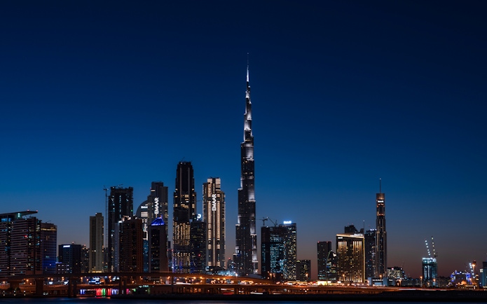 Dubai skyline at night featuring the illuminated Burj Khalifa on the Big Bus Dubai Night Tour.