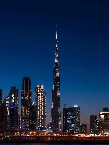 Dubai skyline at night featuring the illuminated Burj Khalifa on the Big Bus Dubai Night Tour.