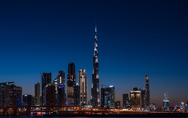 Dubai skyline at night featuring the illuminated Burj Khalifa on the Big Bus Dubai Night Tour.