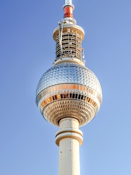 Berlin TV Tower against clear blue sky.