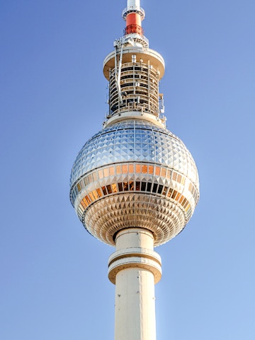Berlin TV Tower against clear blue sky.