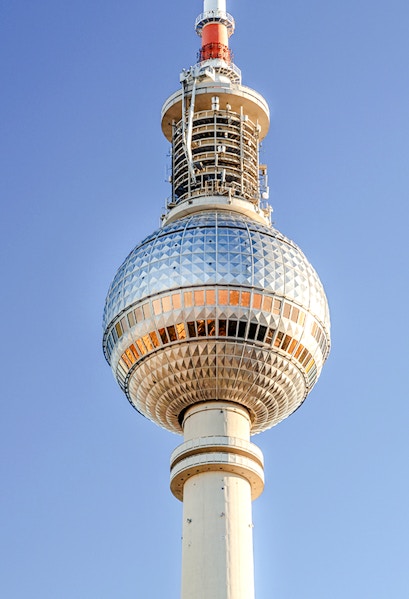 Berlin TV Tower against clear blue sky.