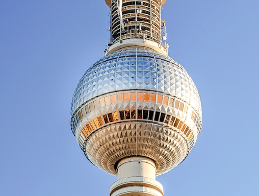Berlin TV Tower against clear blue sky.