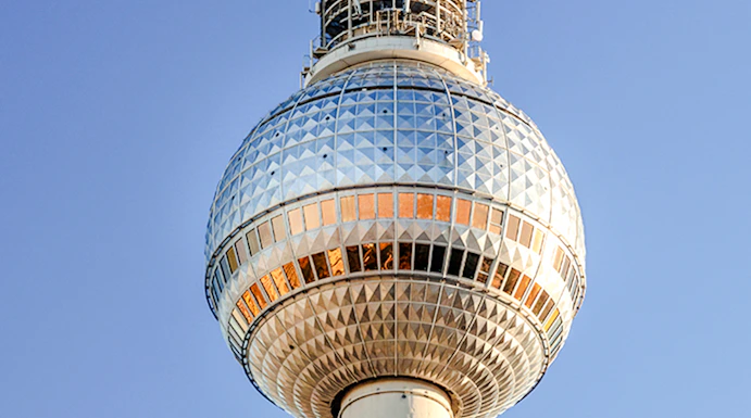 Berlin TV Tower against clear blue sky.