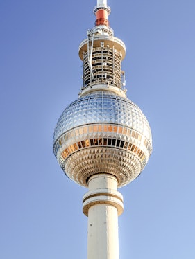 Berlin TV Tower against clear blue sky.