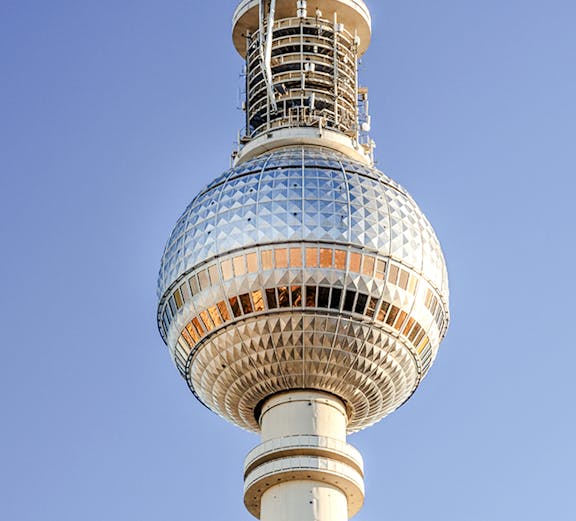 Berlin TV Tower against clear blue sky.