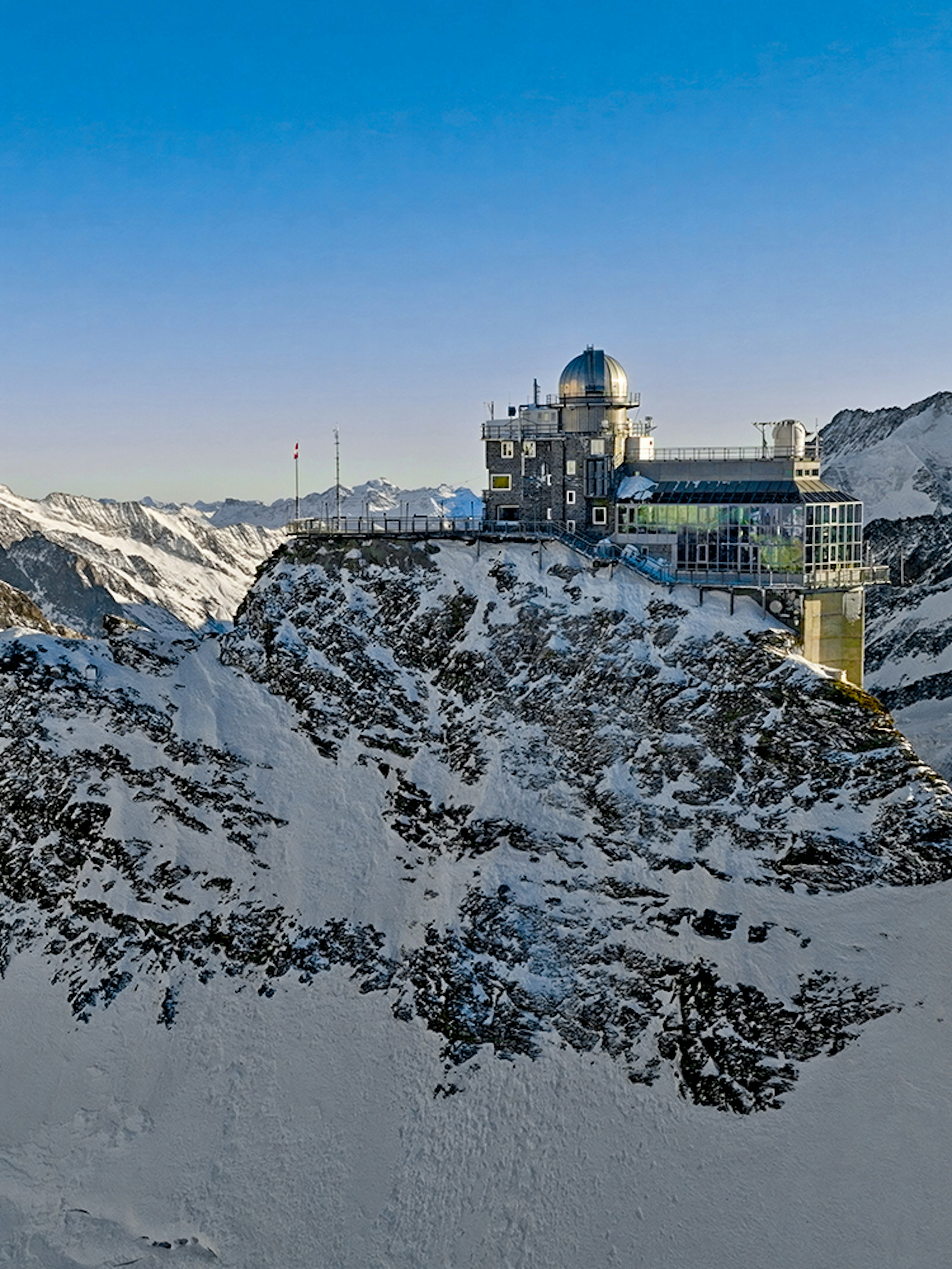 Jungfraujoch observatory on snowy mountain peak, Swiss Alps, during day trip from Zürich.