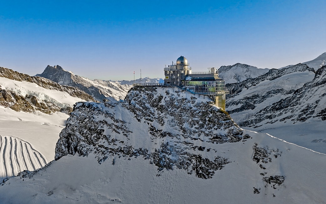Jungfraujoch observatory on snowy mountain peak, Swiss Alps, during day trip from Zürich.