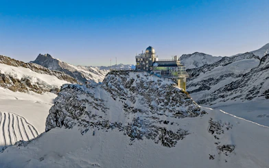 Jungfraujoch observatory on snowy mountain peak, Swiss Alps, during day trip from Zürich.