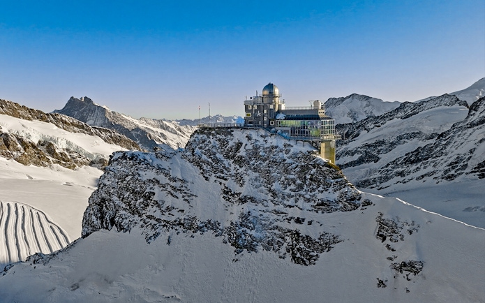 Jungfraujoch observatory on snowy mountain peak, Swiss Alps, during day trip from Zürich.