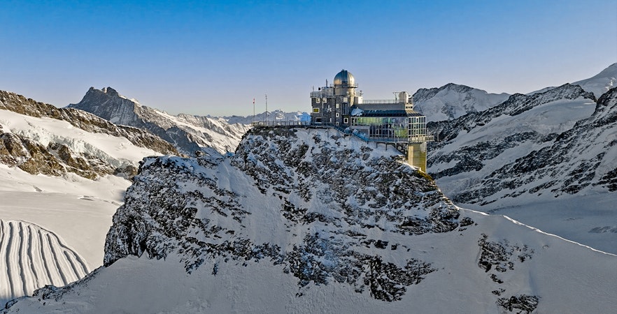 Jungfraujoch observatory on snowy mountain peak, Swiss Alps, during day trip from Zürich.