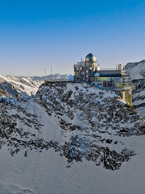 Jungfraujoch observatory on snowy mountain peak, Swiss Alps, during day trip from Zürich.