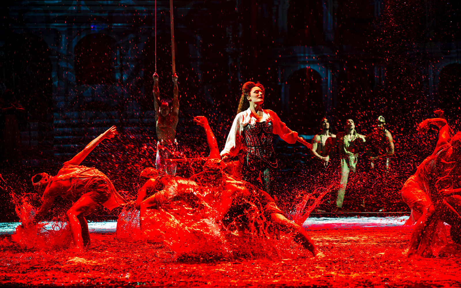 Performers splashing water during House of Dancing Water show.