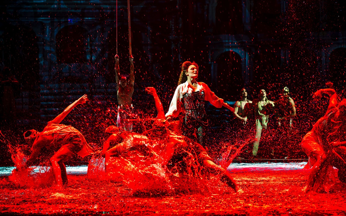 Performers splashing water during House of Dancing Water show.
