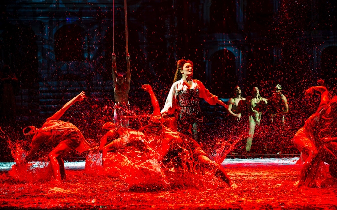 Performers splashing water during House of Dancing Water show.