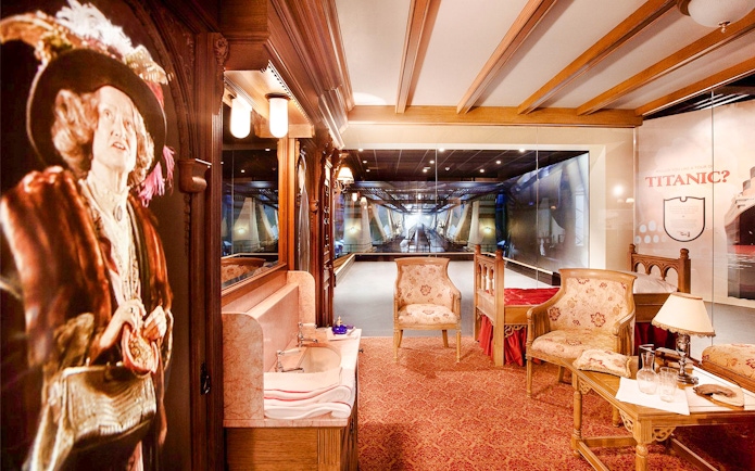 Titanic museum interior with period furniture and ship model display.
