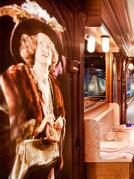 Titanic museum interior with period furniture and ship model display.