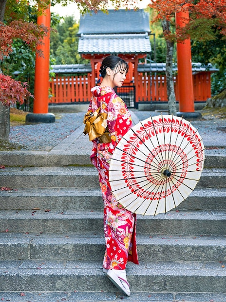 Woman in kimono holding parasol in Kyoto Arashiyama.