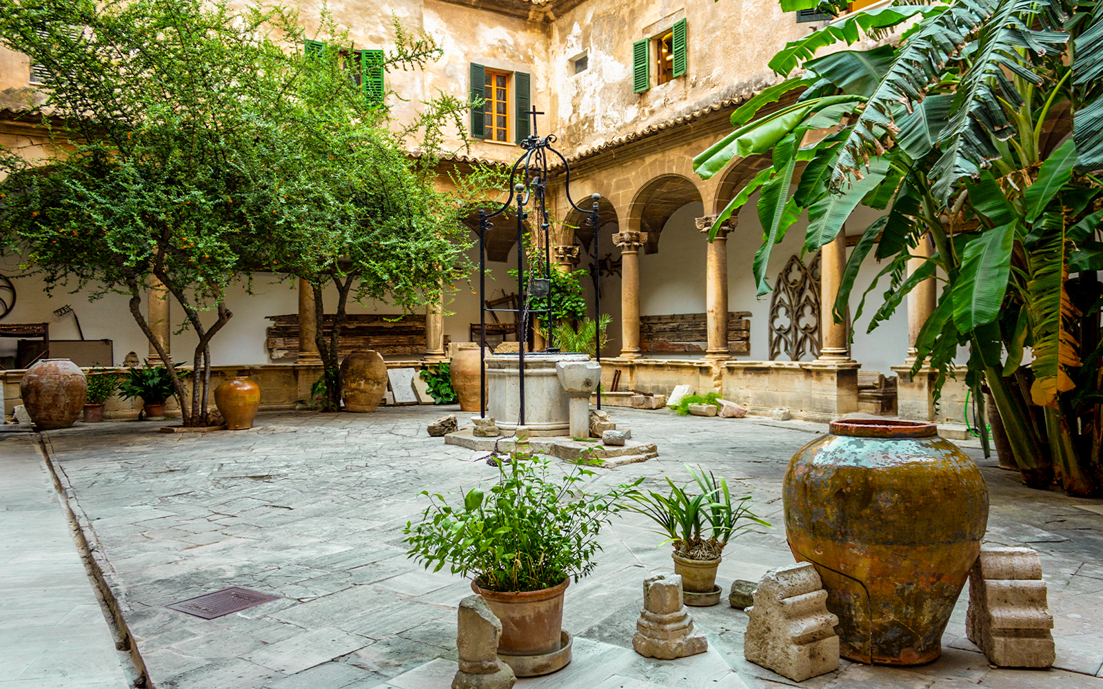 Cloister of Palma Cathedral with arched walkways and stone columns in Palma de Mallorca, Spain.