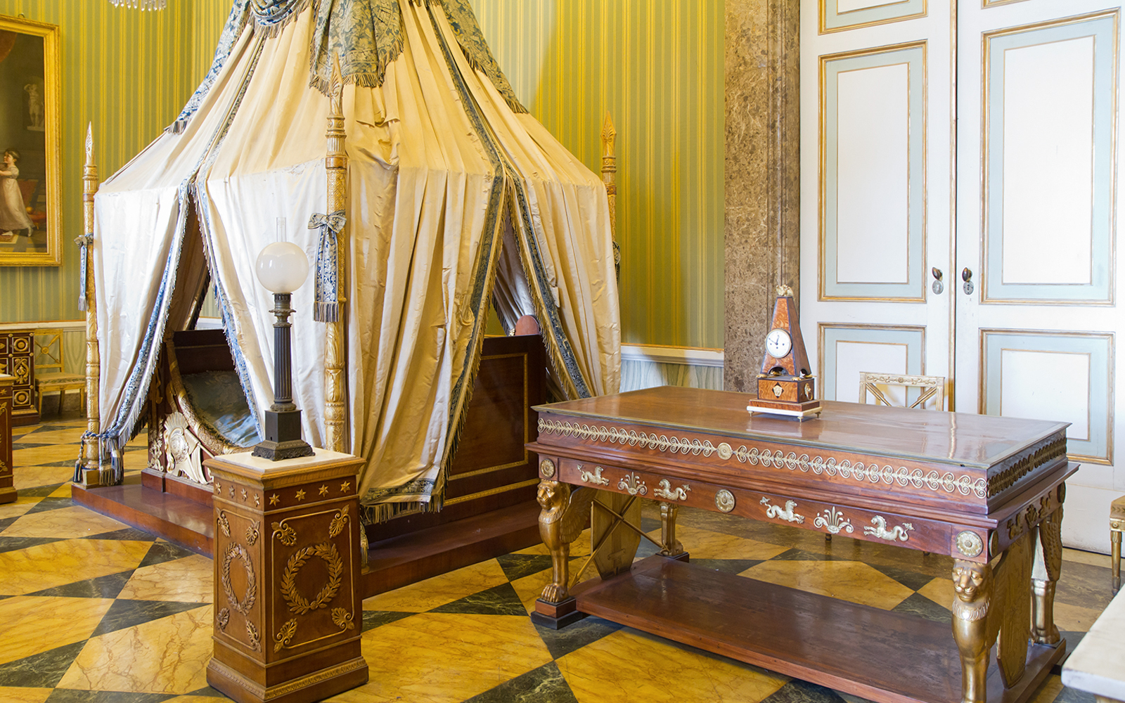 Royal Palace of Caserta bedroom with ornate canopy bed and antique furniture.