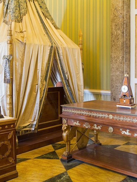 Royal Palace of Caserta bedroom with ornate canopy bed and antique furniture.