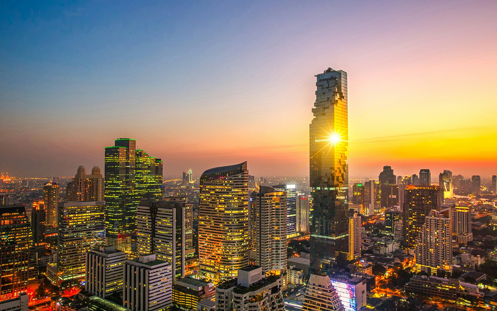 The sun reflecting off King Power Mahanakhon, the tallest building in Bangkok, Thailand