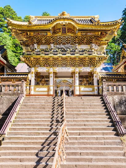 Yomeimon Gate at Toshogu Shrine in Nikko, Japan, with ornate carvings and stone steps.