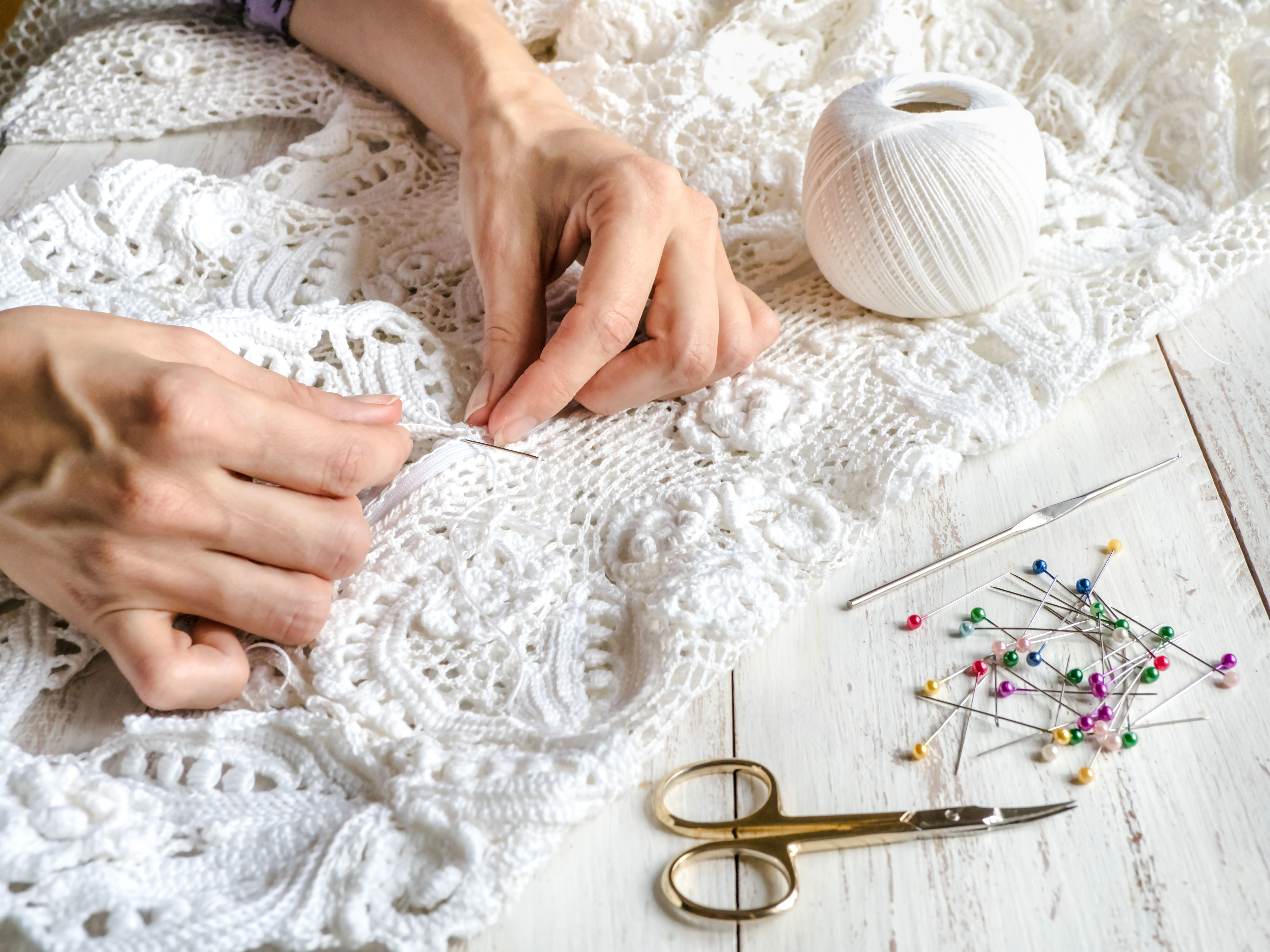 Hands embroidering lace at Bordal Embroidery Factory, Madeira.