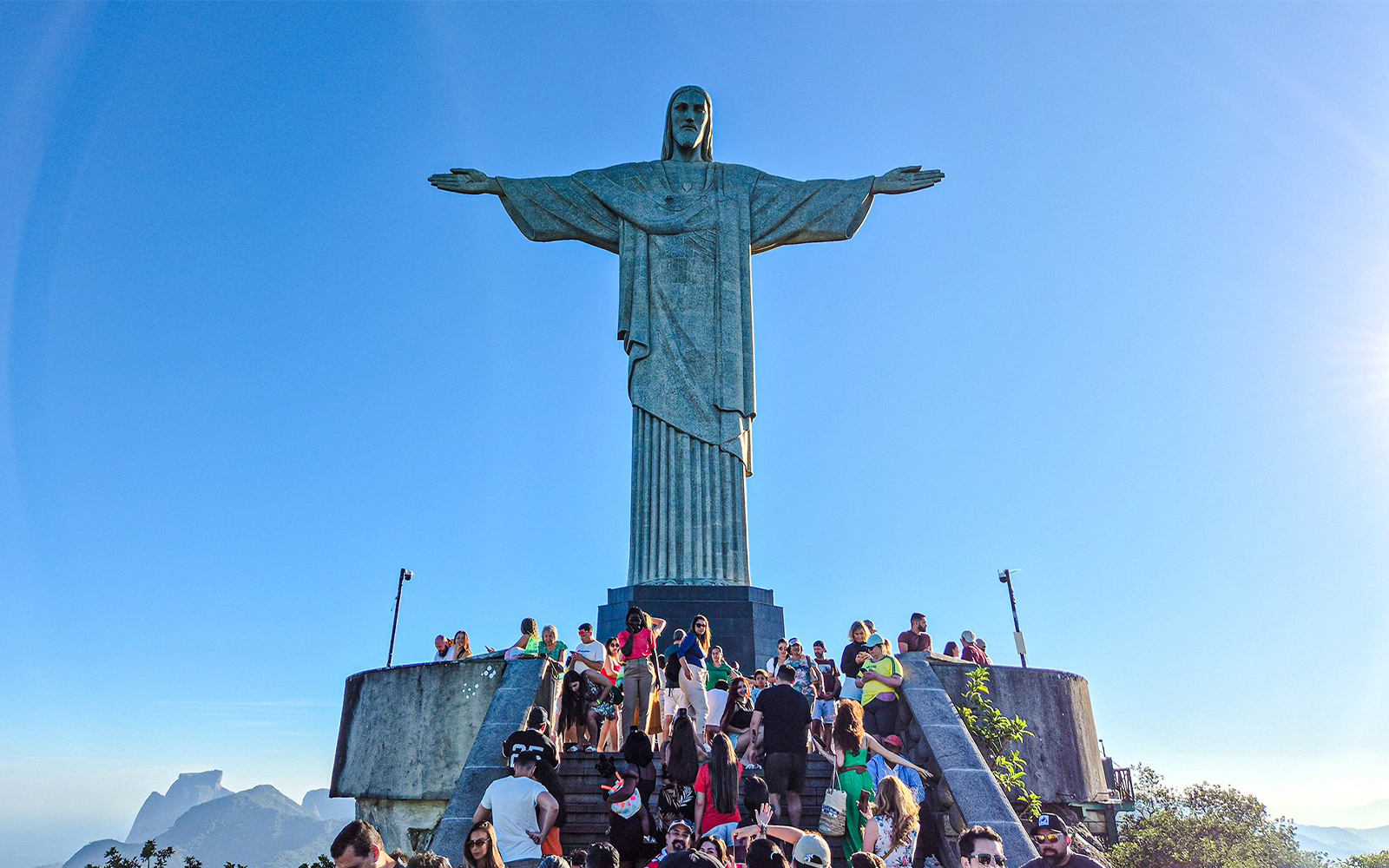 Tourists gather at the base of Christ the Redeemer statue in Rio de Janeiro, Brazil.